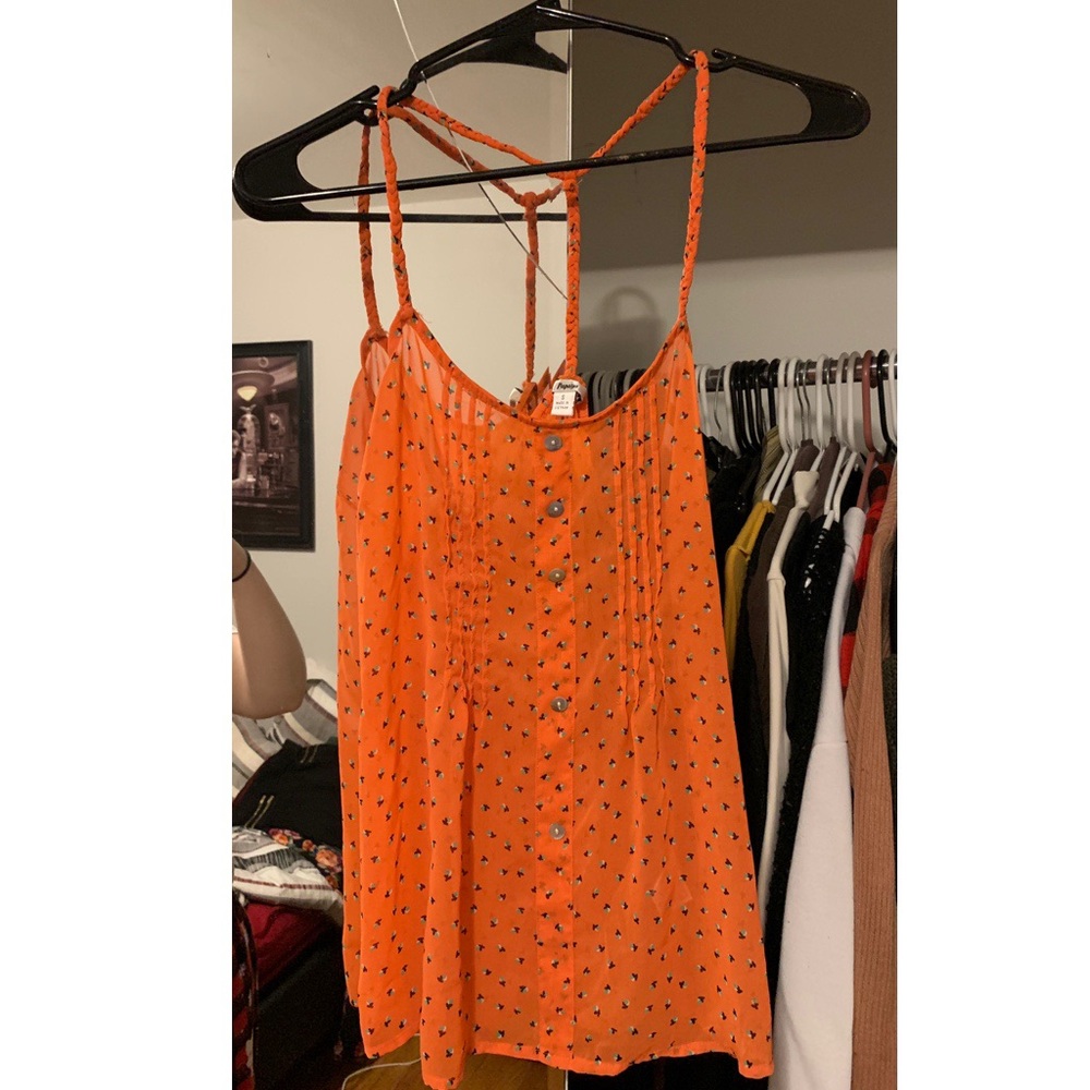 Orange tank top with floral like design